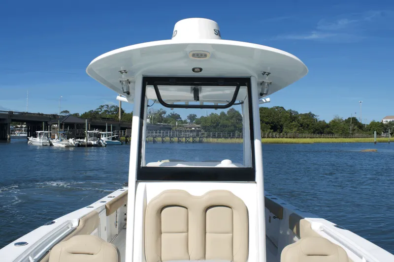 Slide: The Image of 2017 Sea Hunt Gamefish 27FS boat on calm water, clear sky background. - 12