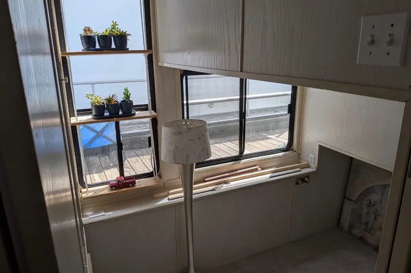 Slide: The Image of Interior of 1996 Stardust Cruisers houseboat with succulents, lamp, and window view. - 22