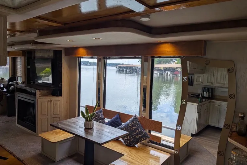 Slide: The Image of Interior of a 1996 Stardust Cruisers houseboat with lake view, dining area, and modern decor. - 14