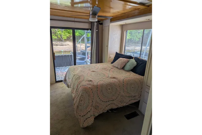 Slide: The Image of Cozy bedroom in 1996 Stardust Cruisers houseboat with patterned bedding and scenic window view. - 15