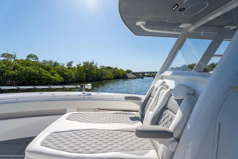Slide: The Image of 2025 Invincible 33 Open Fisherman boat interior with luxurious seating on a sunny day. - 33