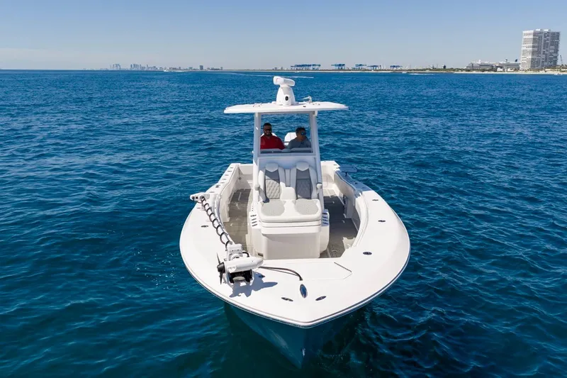 Slide: The Image of 2025 Invincible 33 Open Fisherman boat cruising on clear blue ocean waters. - 53