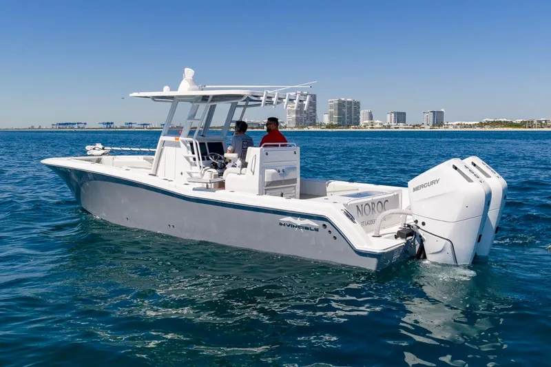 Slide: The Image of 2025 Invincible 33 Open Fisherman boat on blue ocean near city skyline. - 50