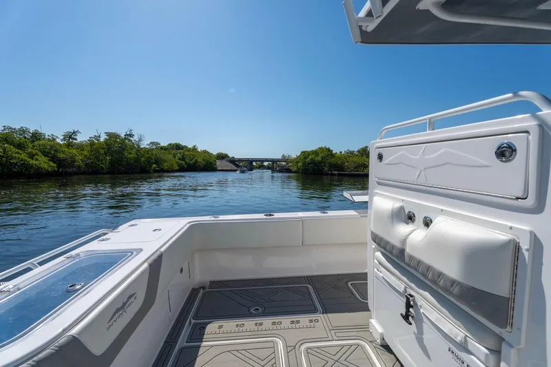 Slide: The Image of Invincible 33 Open Fisherman 2025 on calm water, showcasing spacious deck and sleek design. - 22