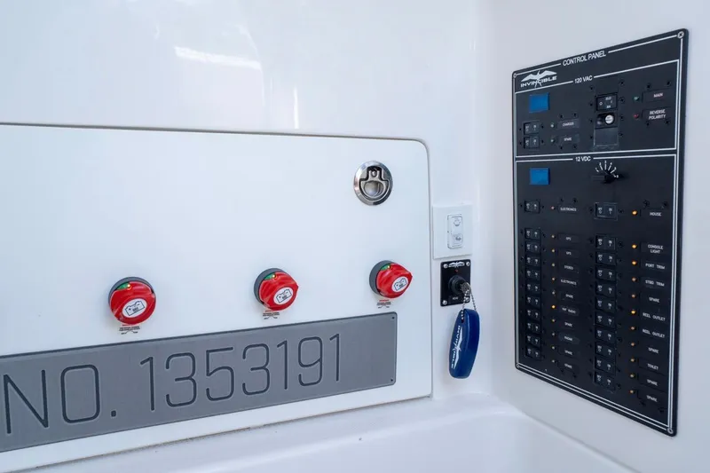 Slide: The Image of Control panel of 2025 Invincible 33 Open Fisherman boat with switches and identification number. - 27