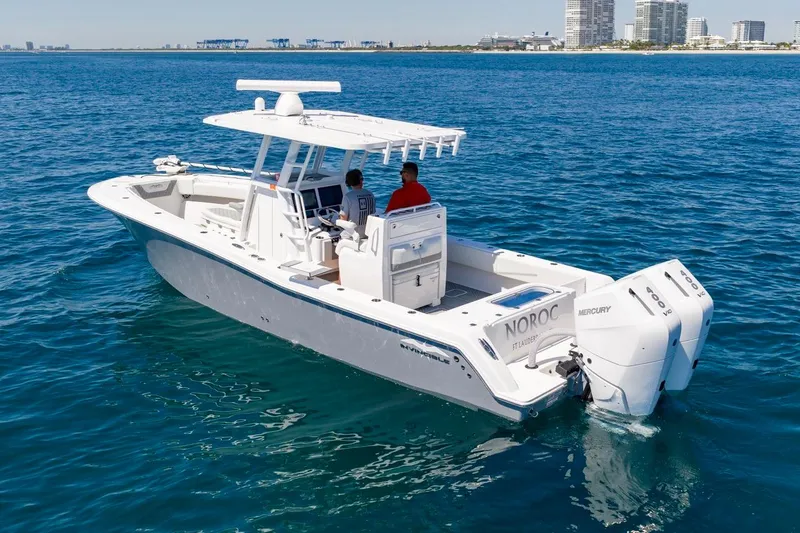 Slide: The Image of 2025 Invincible 33 Open Fisherman boat cruising on clear blue ocean waters. - 51