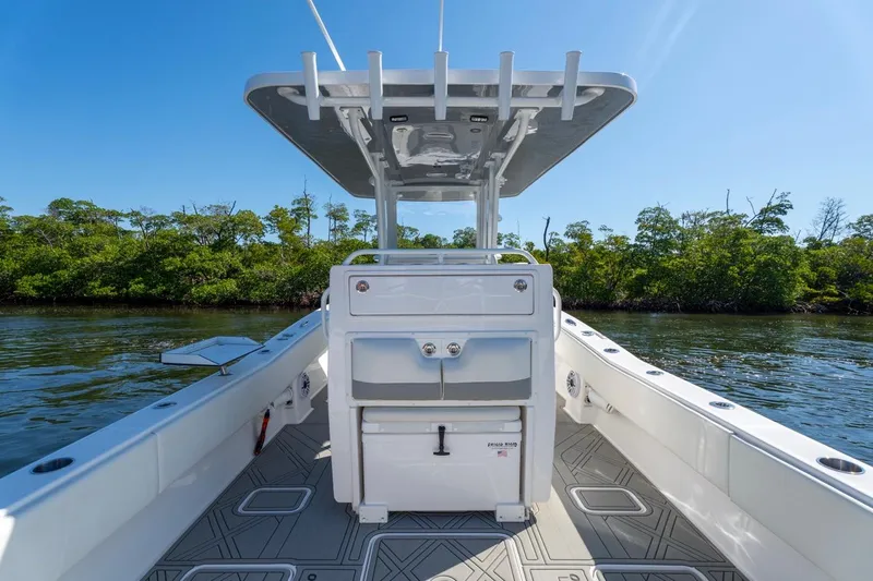 Slide: The Image of 2025 Invincible 33 Open Fisherman boat on calm water, featuring sleek design and spacious deck. - 21