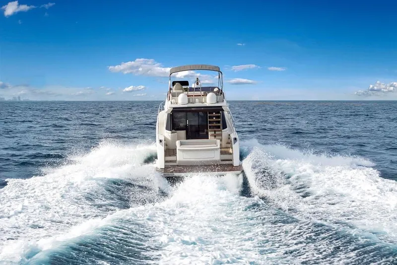 Slide: The Image of 2021 Ferretti Yachts 500 cruising on open sea under clear blue sky. - 21