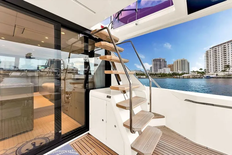 Slide: The Image of Luxurious 2021 Ferretti Yachts 500 interior with modern staircase and waterfront view. - 28