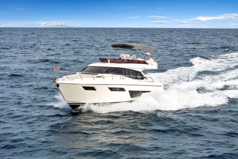 Slide: The Image of 2021 Ferretti Yachts 500 cruising on open sea under clear blue sky. - 13