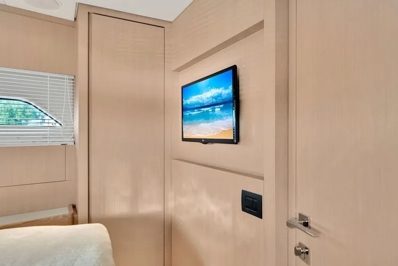 Slide: The Image of Interior of 2021 Ferretti Yachts 500 with wall-mounted TV and window blinds. - 76