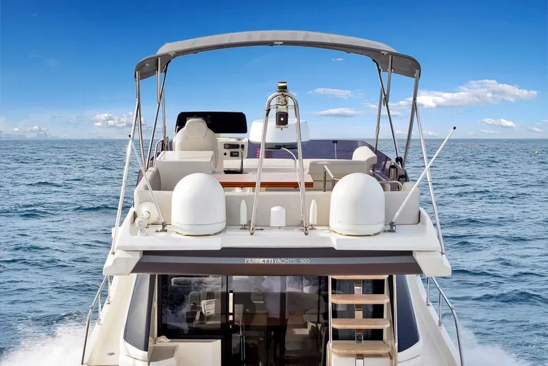 Slide: The Image of 2021 Ferretti Yachts 500 cruising on open sea under clear blue sky. - 20