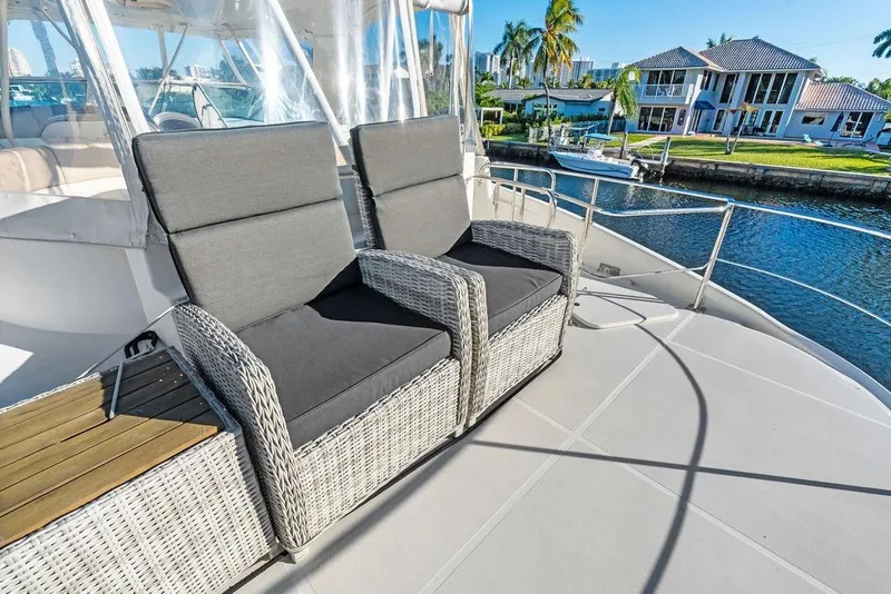 Slide: The Image of Luxury seating on 2009 Carver 56 Voyager SE yacht deck, overlooking waterfront homes. - 42