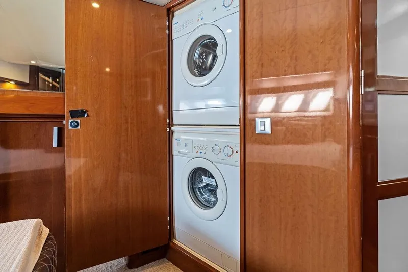 Slide: The Image of 2009 Carver 56 Voyager SE yacht with built-in washer and dryer in wooden cabinet. - 29