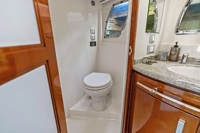Slide: The Image of Luxurious bathroom in 2009 Carver 56 Voyager SE yacht with modern fixtures and wood accents. - 30