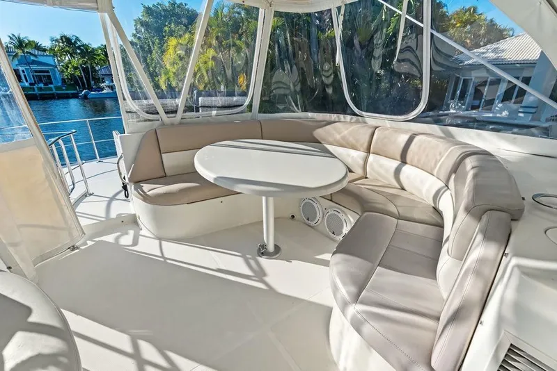 Slide: The Image of Luxurious seating area on a 2009 Carver 56 Voyager SE yacht, featuring a round table. - 40