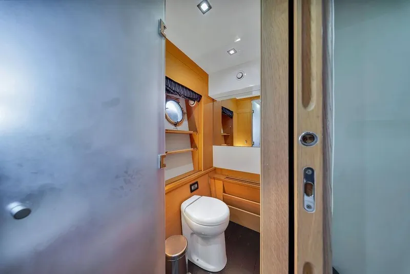 Slide: The Image of Luxury yacht bathroom interior with modern fixtures, wooden accents, and a porthole window. Aicon 75, 2008. - 92