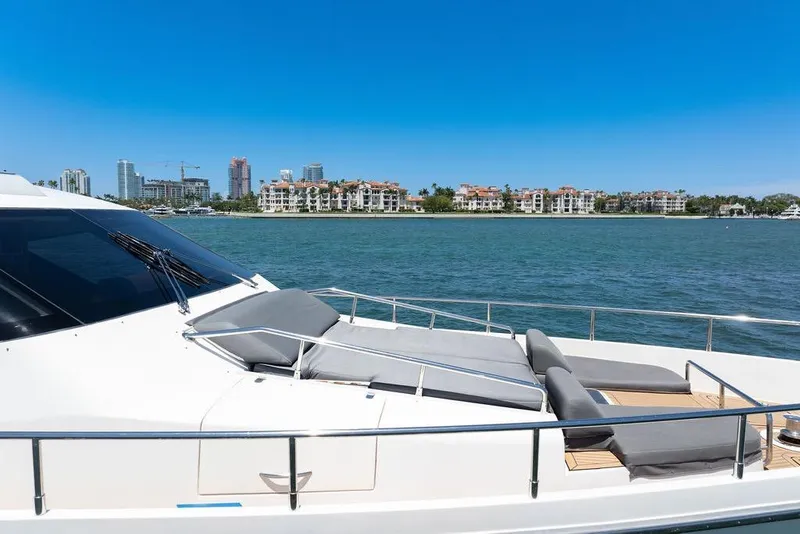 Slide: The Image of Luxurious 2008 Aicon 75 yacht with sun loungers, cruising near waterfront cityscape. - 41