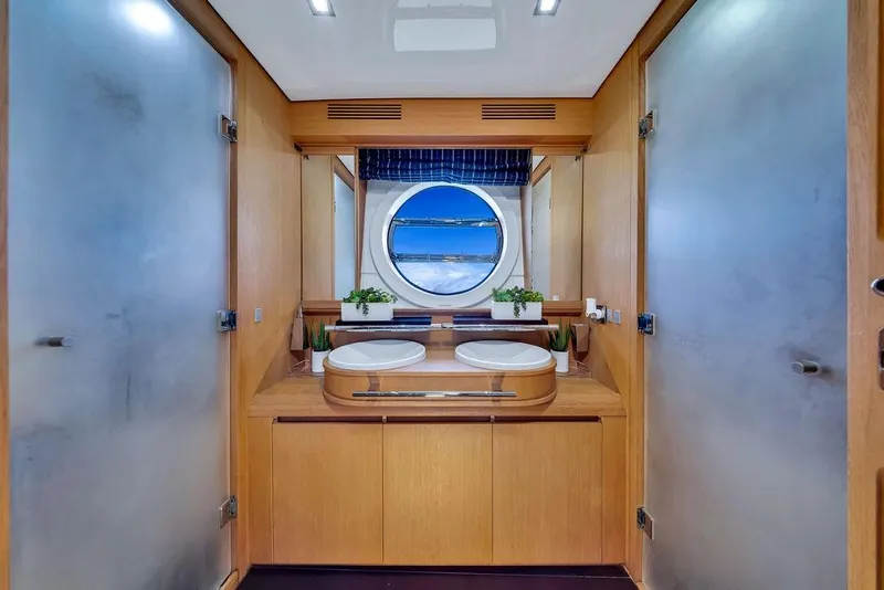 Slide: The Image of Luxurious yacht bathroom with dual sinks, round window, and wooden cabinetry on Aicon 75, 2008 model. - 91