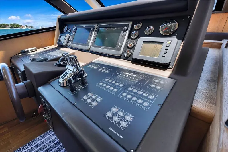 Slide: The Image of Control panel of a 2008 Aicon 75 yacht, featuring navigation and monitoring instruments. - 73