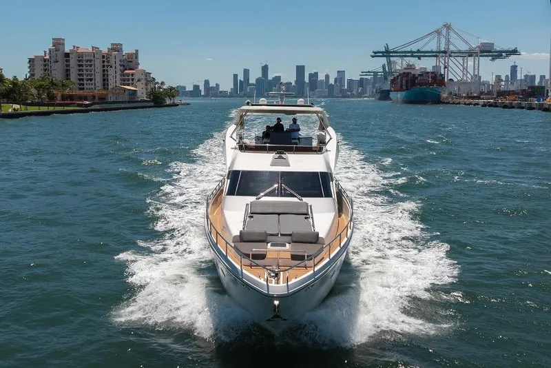 Slide: The Image of Luxury Aicon 75 yacht cruising in a bustling harbor, city skyline in background. - 15