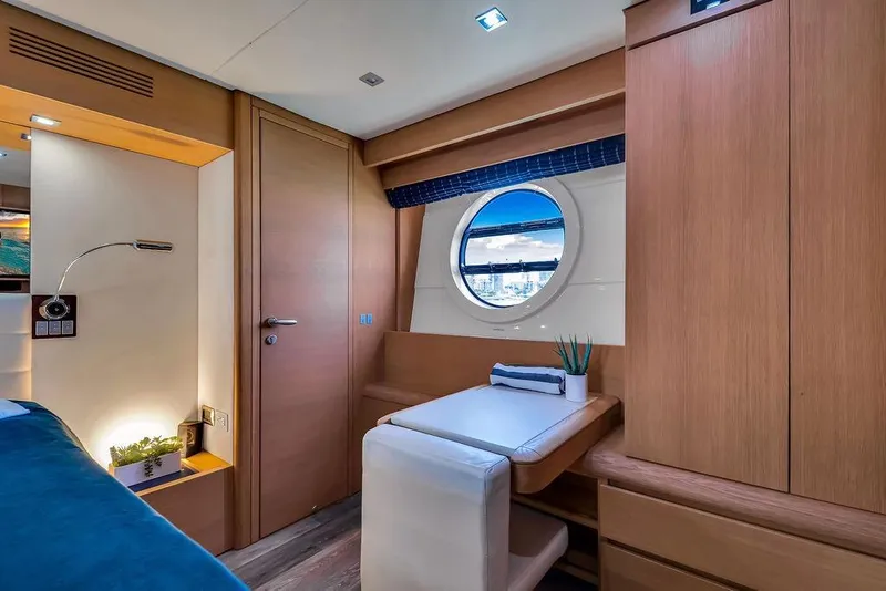Slide: The Image of Luxurious cabin interior of 2008 Aicon 75 yacht with porthole and wooden furnishings. - 100