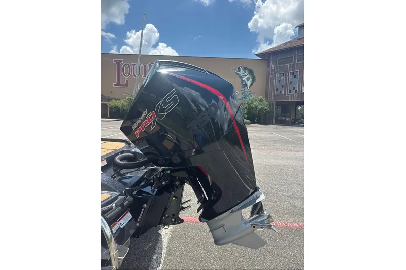 Slide: The Image of Outboard motor on a Nitro Z20 XL 2027 boat, parked outdoors under a blue sky. - 8