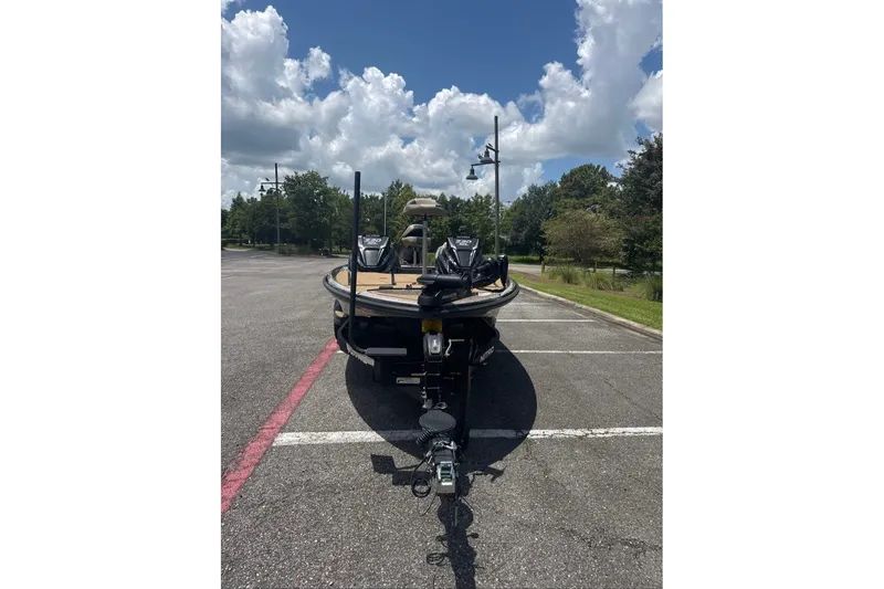 Slide: The Image of 2027 Nitro Z20 XL boat parked in a sunny lot with cloudy sky. - 1