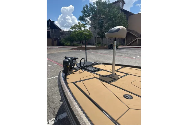 Slide: The Image of 2027 Nitro Z20 XL boat deck with trolling motor in a parking lot. - 4