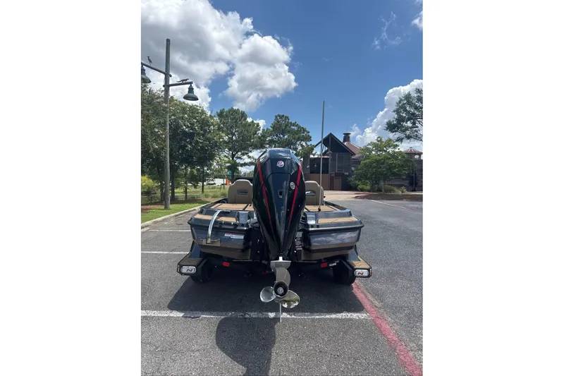 Slide: The Image of 2027 Nitro Z20 XL boat parked, rear view, under a clear blue sky. - 3