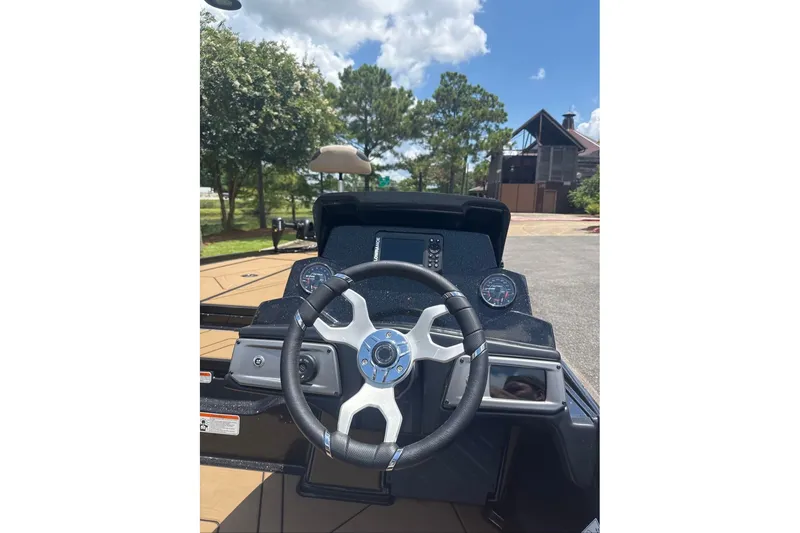 Slide: The Image of 2027 Nitro Z20 XL boat dashboard with steering wheel and gauges under clear sky. - 9
