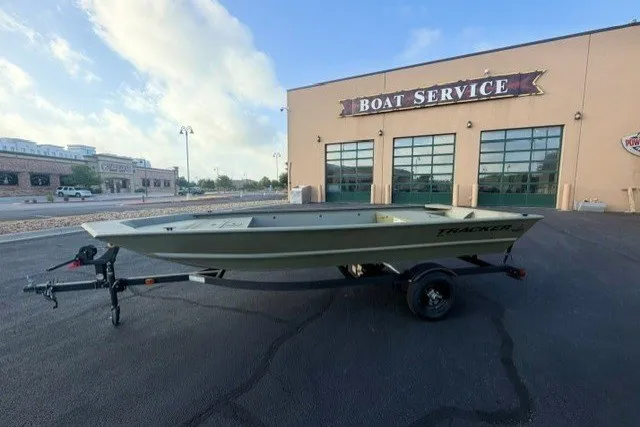 The Image of 2027 Tracker Grizzly 1648 Utility boat on trailer outside boat service center. - 0
