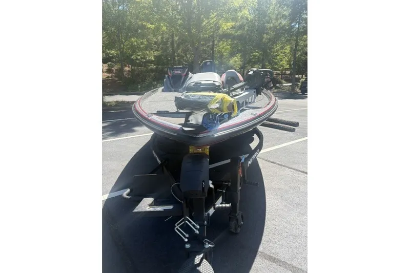 Slide: The Image of 2027 Nitro Z21 XL Pro boat parked in a sunny outdoor setting. - 8