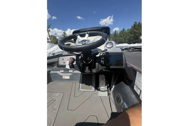 Slide: The Image of 2027 Nitro Z21 XL Pro boat dashboard with steering wheel and control panel under clear sky. - 3
