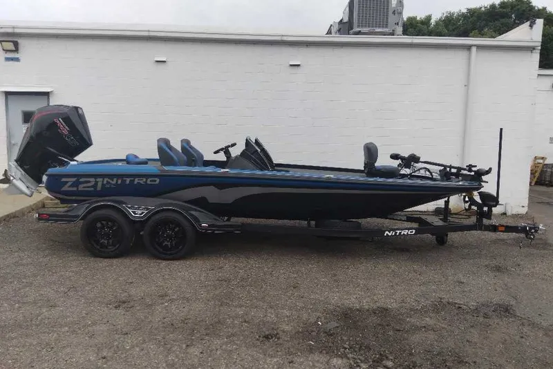 The Image of 2027 Nitro Z21 XL Pro boat on trailer, parked outdoors. - 0