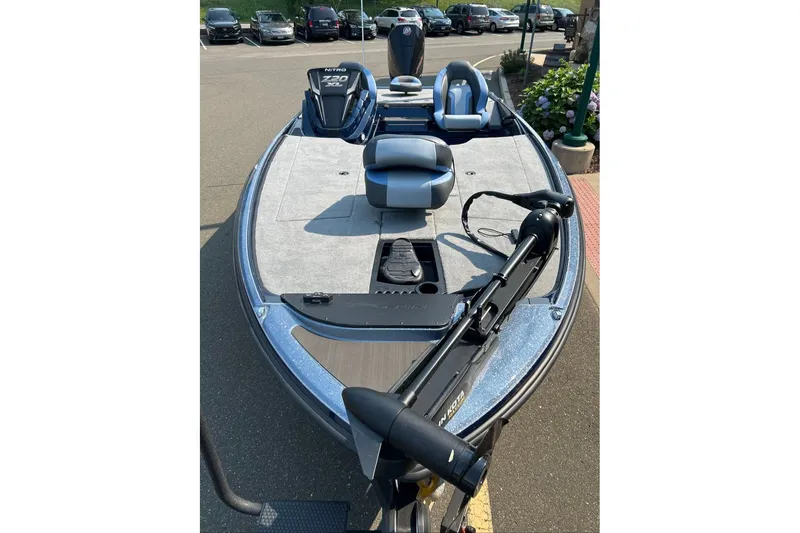 Slide: The Image of 2027 Nitro Z20 XL boat with sleek design and modern seating, parked outdoors. - 2