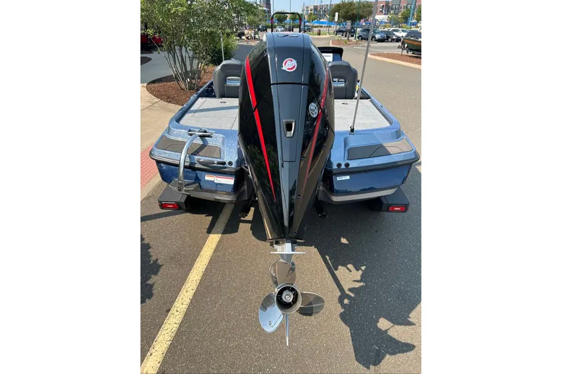 Slide: The Image of 2027 Nitro Z20 XL boat with powerful outboard motor, parked on a sunny street. - 3