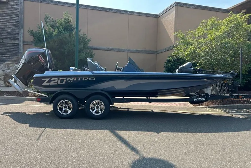 The Image of 2027 Nitro Z20 XL boat on trailer, parked outdoors. - 0