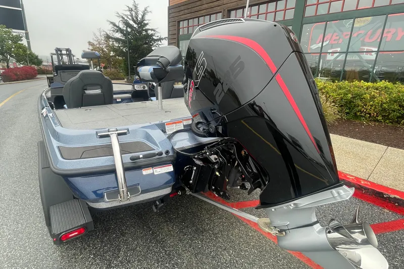 Slide: The Image of 2027 Nitro Z20 XL boat with powerful outboard motor, parked outdoors. - 1