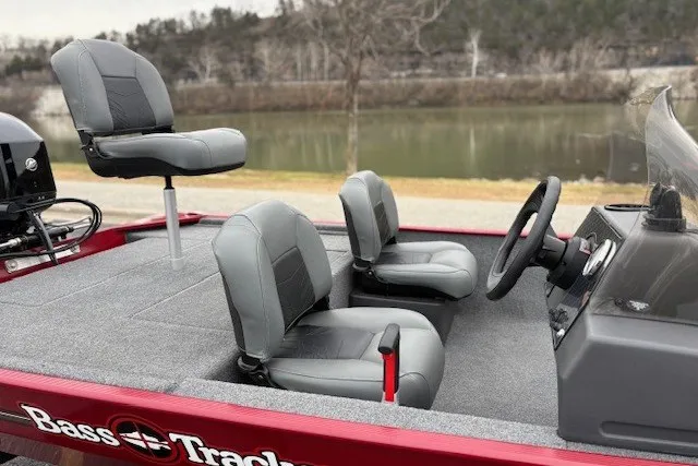 Slide: The Image of 2027 Tracker Bass Tracker Classic XL boat interior with gray seats by a lake. - 13