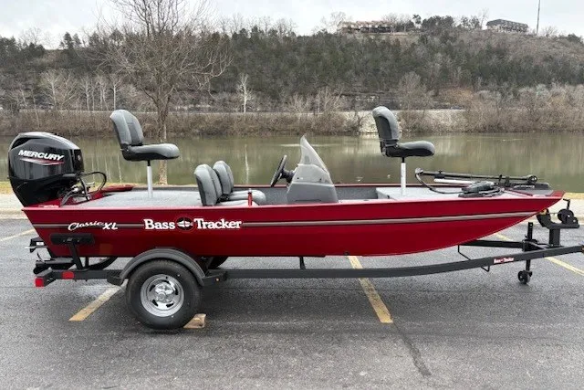 The Image of 2027 Tracker Bass Tracker Classic XL boat on trailer by a lake. - 0