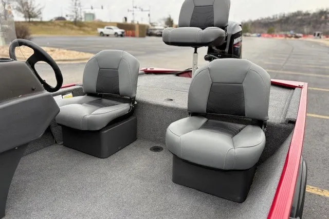 Slide: The Image of 2027 Tracker Bass Tracker Classic XL boat interior with gray seating and steering wheel. - 16