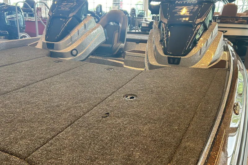 Slide: The Image of 2027 Nitro Z21 XL Pro boat interior with carpeted deck and dual consoles. - 10