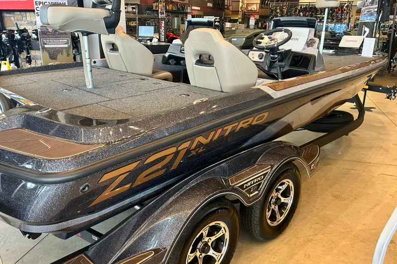 Slide: The Image of 2027 Nitro Z21 XL Pro boat displayed in showroom, featuring sleek design and modern seating. - 6