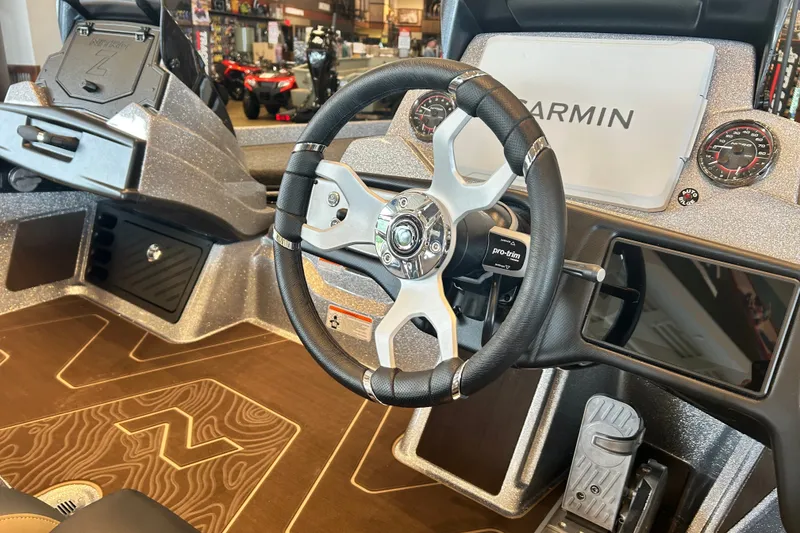 Slide: The Image of 2027 Nitro Z21 XL Pro boat dashboard with Garmin display and steering wheel. - 16