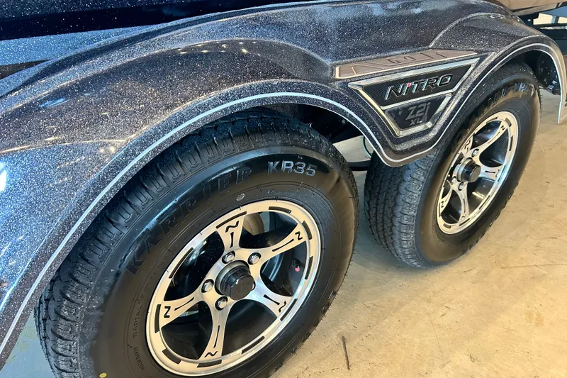 Slide: The Image of 2027 Nitro Z21 XL Pro trailer with shiny metallic finish and dual wheels. - 19