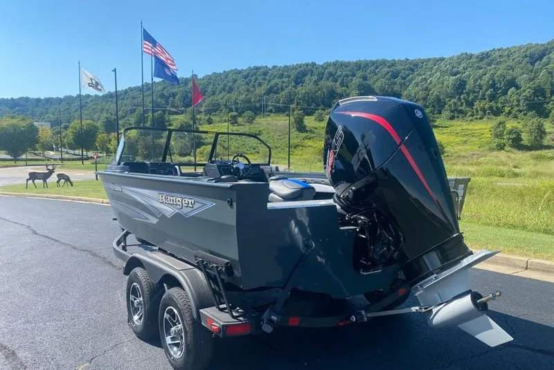 Slide: The Image of 2026 Ranger VX1888 WT boat on trailer, scenic background with flags and greenery. - 1