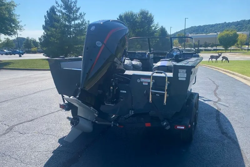 Slide: The Image of 2026 Ranger VX1888 WT boat with powerful outboard motor in a parking lot. - 5