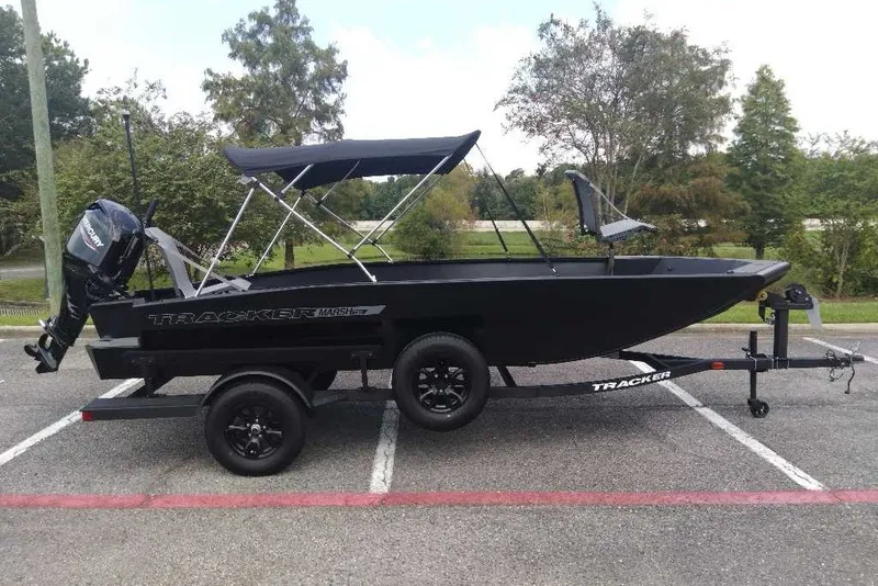 The Image of 2027 Tracker Grizzly 1756 T Marsh boat on trailer, parked outdoors. - 0