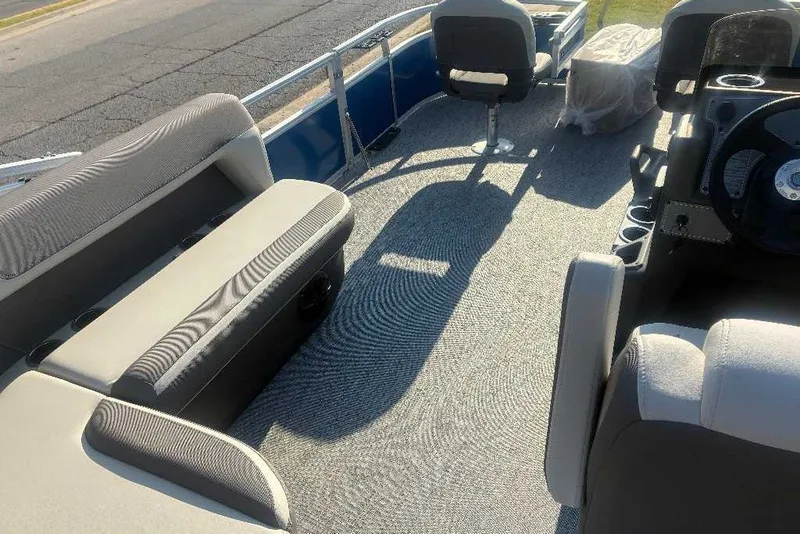 Slide: The Image of 2027 Sun Tracker SportFish 20 DLX pontoon boat interior with seating and steering console. - 95